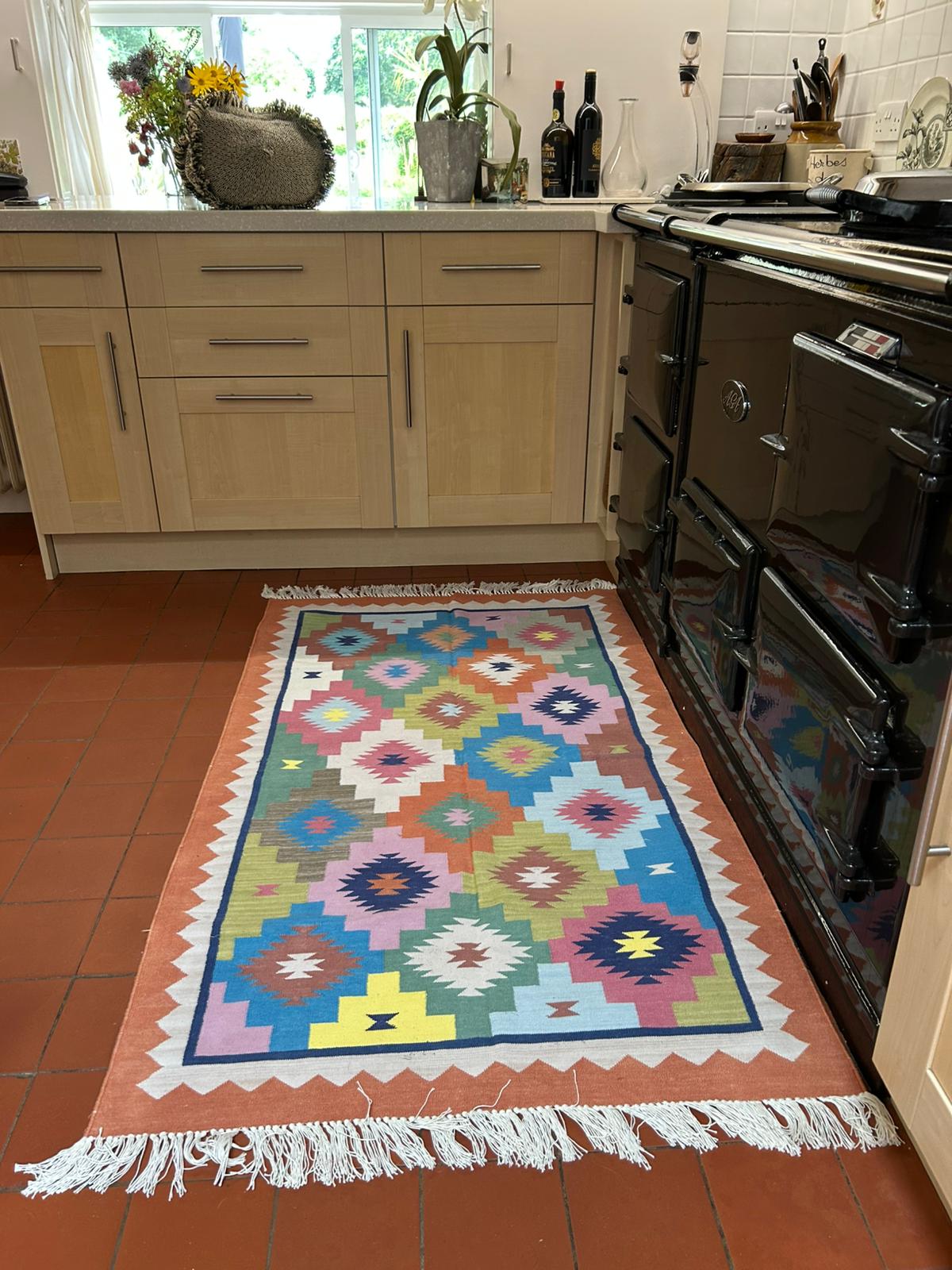 The beautiful rug is a perfect match to the terracotta floor in our kitchen, with all the colours brightening the area. The borders love it too…