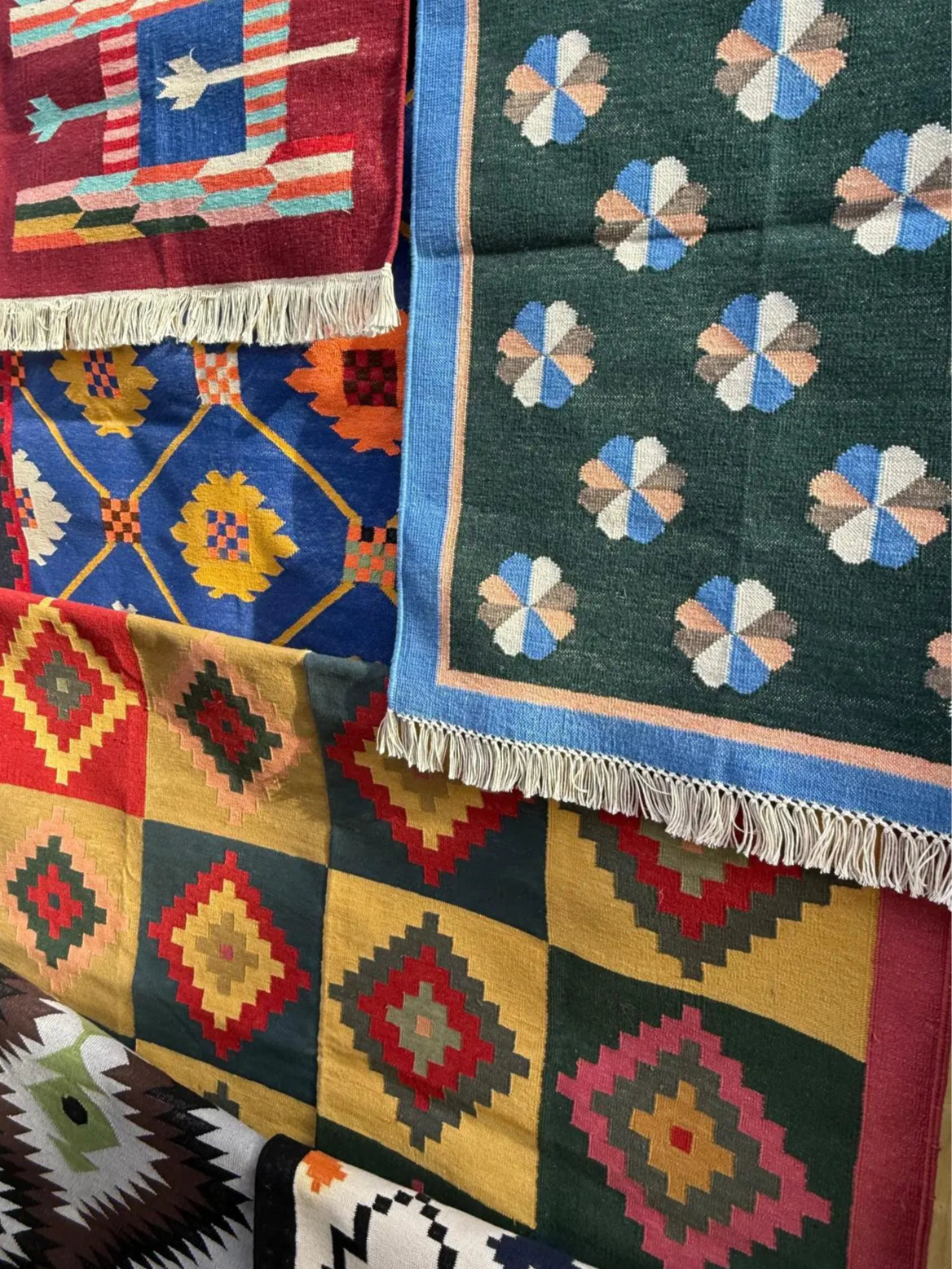 Collection of colorful patterned rugs with various designs.
